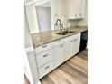 Modern kitchen with white cabinets, granite countertops, and stainless steel appliances at 10933 Harrowfield Rd, Charlotte, NC 28226