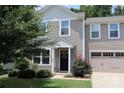Charming two-story home featuring a welcoming front porch and attached garage at 1128 Tangle Ridge Se Dr, Concord, NC 28025