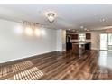 Spacious living room showcasing wood floors and an open layout to the kitchen at 1128 Tangle Ridge Se Dr, Concord, NC 28025