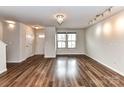 Bright and airy living room with beautiful wood floors and modern lighting at 1128 Tangle Ridge Se Dr, Concord, NC 28025