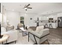 Inviting living space showcasing wood floors and seamless transition to the well-lit kitchen at 114 I K Beatty St, Charlotte, NC 28214