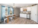 Eat-in kitchen featuring white cabinets, stainless steel appliances, and ample natural light at 1140 Roberts St, China Grove, NC 28023