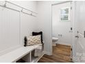Mudroom showcases convenient bench with storage, coat hooks, and a view into the powder room at 118 I K Beatty St, Charlotte, NC 28214