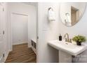 Well-lit powder room with modern sink and fixtures adjacent to the mudroom in neutral color palette at 118 I K Beatty St, Charlotte, NC 28214