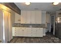 Well-lit kitchen showcasing ample cabinet space and modern backsplash at 1255 Darby Rd, Chester, SC 29706