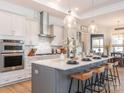 Modern kitchen with stainless steel appliances and a large island at 14543 Crosswater Ln, Charlotte, NC 28278