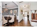 Elegant dining room with hardwood floors, stylish lighting, and access to the kitchen at 15313 Wedgewood Commons Dr, Charlotte, NC 28277