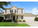Two-story house with beige siding, a dark-colored front door, and a two-car garage at 1614 Hardy Dr, Rock Hill, SC 29732