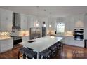 Modern kitchen with white cabinets, stainless steel appliances, and a large island at 2510 Lentz Rd, China Grove, NC 28023