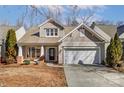 Inviting home with a two-car garage, neutral siding, manicured landscaping, and a covered front porch at 3323 Darlington Rd, Matthews, NC 28105