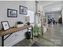 Inviting foyer with wood floors, console table, and staircase leading to the upper level at 343 Embers Ln, Clover, SC 29710
