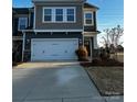 Two-story home with gray siding, two-car garage, and landscaped lawn at 343 Embers Ln, Clover, SC 29710