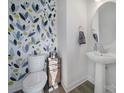 Stylish half-bathroom featuring a pedestal sink and designer wallpaper at 343 Embers Ln, Clover, SC 29710