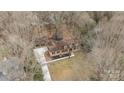 Housetop view of home, driveway, and surrounding trees at 415 Trafalgar Pl, Matthews, NC 28105