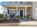 Inviting front porch with seating, decorative plants, and a welcoming entryway at 4442 Golden View Dr, Charlotte, NC 28278