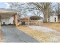 Carport featuring convenient parking and a gravel driveway on a residential property at 523 Eastway Ave, Kannapolis, NC 28083