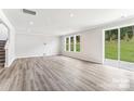 Spacious Gathering room with hardwood floors and sliding glass doors leading to backyard at 7120 Wayfarer Dr # 0079, Charlotte, NC 28269