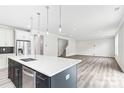 Open floor plan showcasing kitchen island and Gathering room with hardwood floors at 7120 Wayfarer Dr # 0079, Charlotte, NC 28269