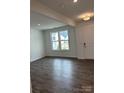 Bright, neutral living room featuring a fireplace, large windows, and wood-look floors at 7120 Wayfarer Dr # 0079, Charlotte, NC 28269