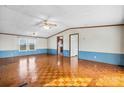 Bright living room featuring parquet floors, a ceiling fan, and neutral wall colors at 760 Tomlin Mill Rd, Statesville, NC 28625
