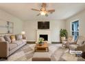 Virtually staged living room featuring a fireplace and comfy seating at 9012 Blue Willow Ln, Charlotte, NC 28227