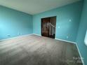 Bright bedroom with teal walls and neutral carpeting at 1112 Culver Spring Way, Charlotte, NC 28215