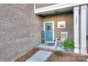 Inviting front porch featuring a white rocking chair and tasteful decor, creating a warm welcome at 1244 Scotch Meadows Loop, Monroe, NC 28110