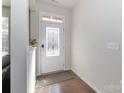 Bright foyer features a decorative front door, fresh paint, and hardwood flooring at 12849 Robert Walker Dr, Davidson, NC 28036