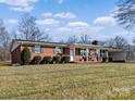 Brick ranch house with landscaping and large yard at 133 Fieldstone Farm Dr, Statesville, NC 28625