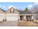 Charming single-Gathering home with a two-car garage, covered entrance, and neutral-colored exterior at 1355 Amberlight Cir, Salisbury, NC 28144