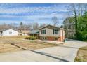 Charming split-level home with brick and siding exterior, long driveway, and classic curb appeal at 1401 Southwest Blvd, Newton, NC 28658