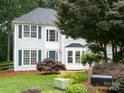 Lovely exterior view showcasing a well-manicured front yard and lush landscaping at 172 Foxtail Dr, Mooresville, NC 28117