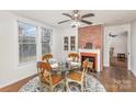 Dining area with hardwood floors, fireplace and glass-top table at 202 W Main St, Cherryville, NC 28021