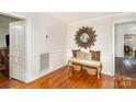 Bright entryway with a bench, baskets, and sunburst mirror at 202 W Main St, Cherryville, NC 28021