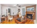 Living room featuring hardwood floors, fireplace and seating area at 202 W Main St, Cherryville, NC 28021