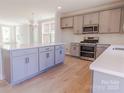 Spacious kitchen with a large island, modern stainless steel appliances, and shaker-style gray cabinets at 216 Gilead Rd, Huntersville, NC 28078