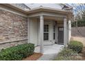 Charming home featuring stone accents, a covered front porch, and well-maintained shrubs at 250 Cherry Tree Dr, Fort Mill, SC 29715