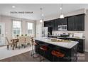 Eat-in kitchen with island seating and dark cabinetry at 2533 Ellen Ave # 1016B, Charlotte, NC 28208