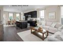 Open concept living room and kitchen with hardwood floors and neutral decor at 2533 Ellen Ave # 1016B, Charlotte, NC 28208