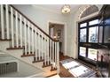 Bright entryway with hardwood floors, staircase, and black front door at 258 Fenton Pl, Charlotte, NC 28207