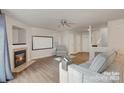 Cozy living room showcasing a fireplace, hardwood flooring, and an open layout at 2604 Cochrane Dr, Charlotte, NC 28269