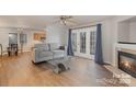 Bright living room with fireplace, hardwood floors, and French doors at 2604 Cochrane Dr, Charlotte, NC 28269