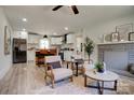 Inviting living room featuring a stone fireplace and open layout to a modern kitchen with a breakfast bar at 2624 Ashley Rd, Charlotte, NC 28208