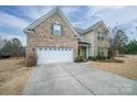 Two-story brick home with a white garage door and driveway at 2748 Smethwick Ln, Gastonia, NC 28056