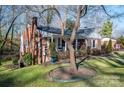 Brick home with a porch and large tree in the yard at 303 Edgewood Rd, Shelby, NC 28150