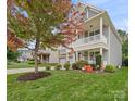 Two-story house with gray siding, stone accents, and fall foliage at 3205 Helmsley Ct, Concord, NC 28027