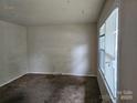 Spacious living room with neutral walls and brown carpet at 3219 Sutton Dr, Charlotte, NC 28216