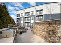 Exterior patio featuring an outdoor kitchen with a grill and a firepit seating area at 3630 N Davidson St # 4406, Charlotte, NC 28205