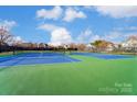 Well-maintained tennis courts in a residential community with blue and green playing surface at 561 Ambergate Nw Pl, Concord, NC 28027