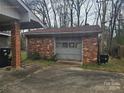 Detached brick garage with a single door at 6209 Channing Ct, Charlotte, NC 28215